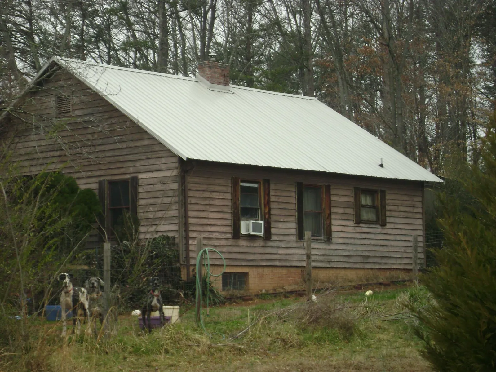White metal roof on an old wood sided farmhouse, from a Metal Roof Installation job in Twin Valley